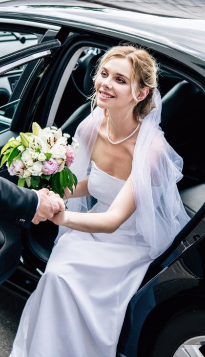 bride coming out from luxury sedan Wedding transportation Bloomington MN luxury sedan service