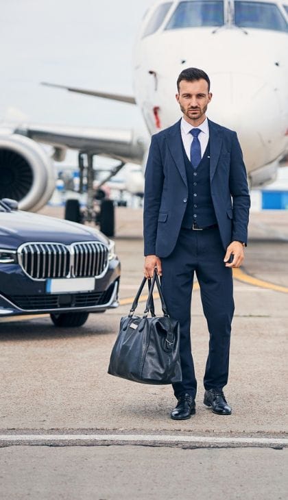 businessman stand at airport Apple Valley car service at MSP Airport terminal