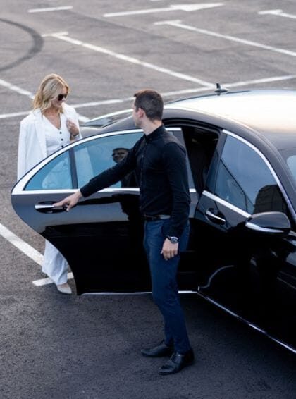 Brainerd Car Service Chauffeur Opening Door For Female Client