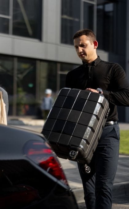 Private MSP car service driver helping traveler with luggage
